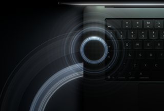 MacBook Pro with PROLED XDR Display, open lid, space black color, keyboard lit by glow from display, circles depicting sonic waves emanate from top and left side of laptop body