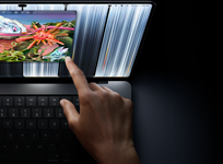 MacBook Pro with PROLED XDR Display, space black color, user resizes a window on screen with their fingertip